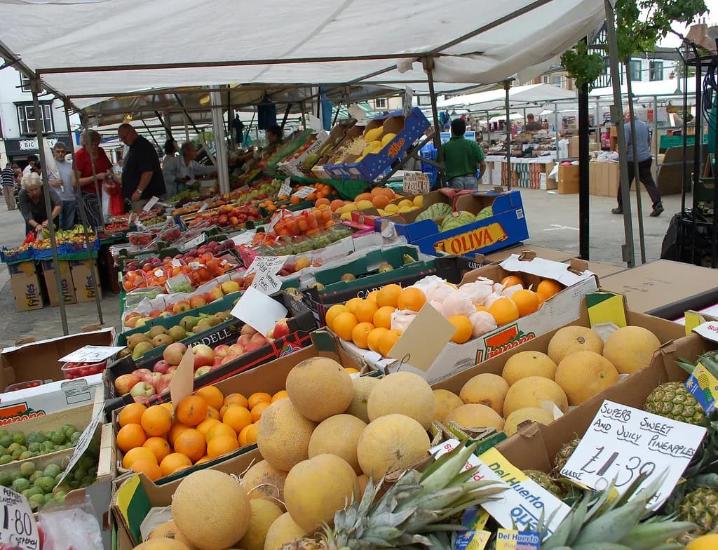 Fruit and vegetable stall with handwritten price cards at Ripon market, North Yorkshire
