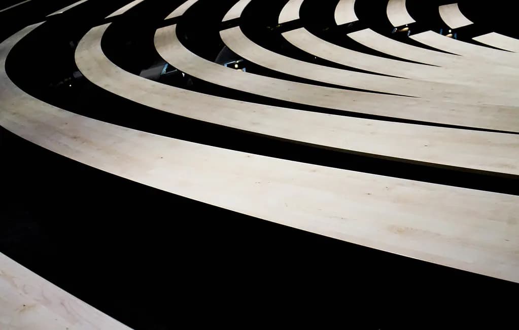 Curved rows of empty lecture theatre seating seen from above