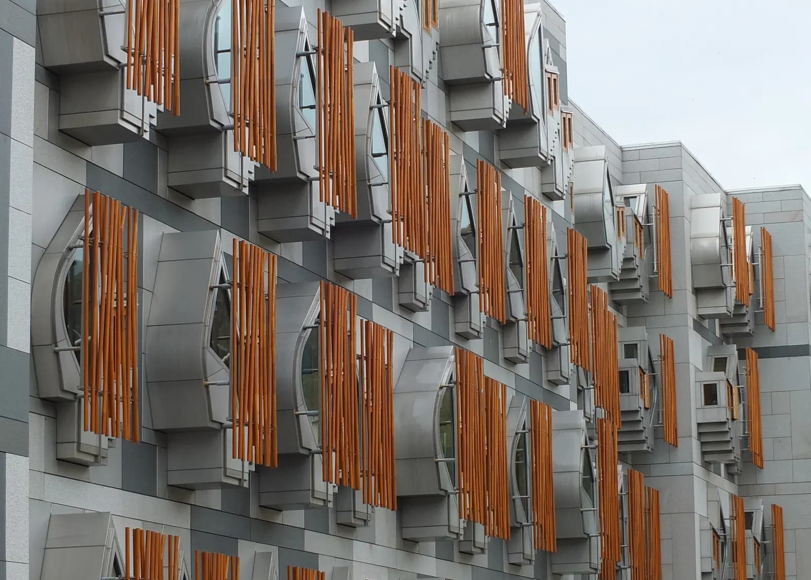 The angular facade of the Scottish Parliament building at Holyrood in Edinburgh, with timber window panels