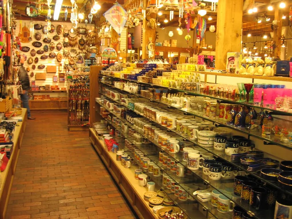 Interior of a souvenir shop in Old Town Albuquerque with pottery, mugs and crafts on shelves