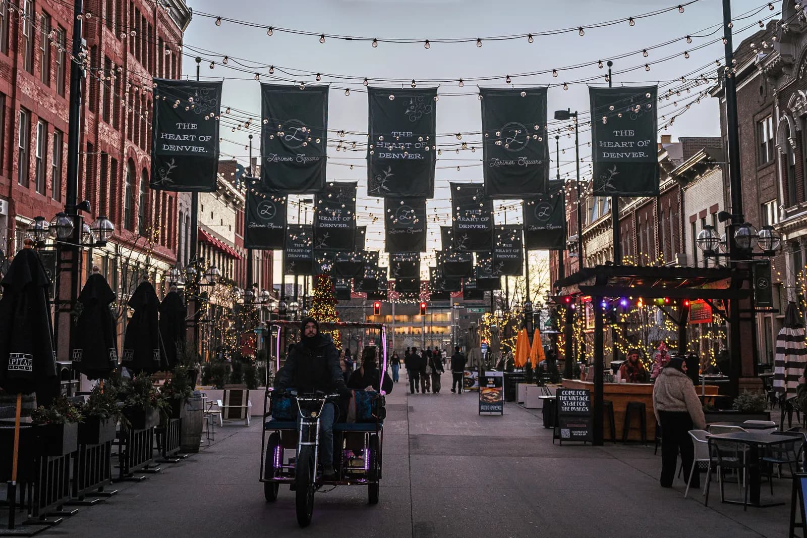 Shops and restaurants under overhead lights in Larimer Square, Denver