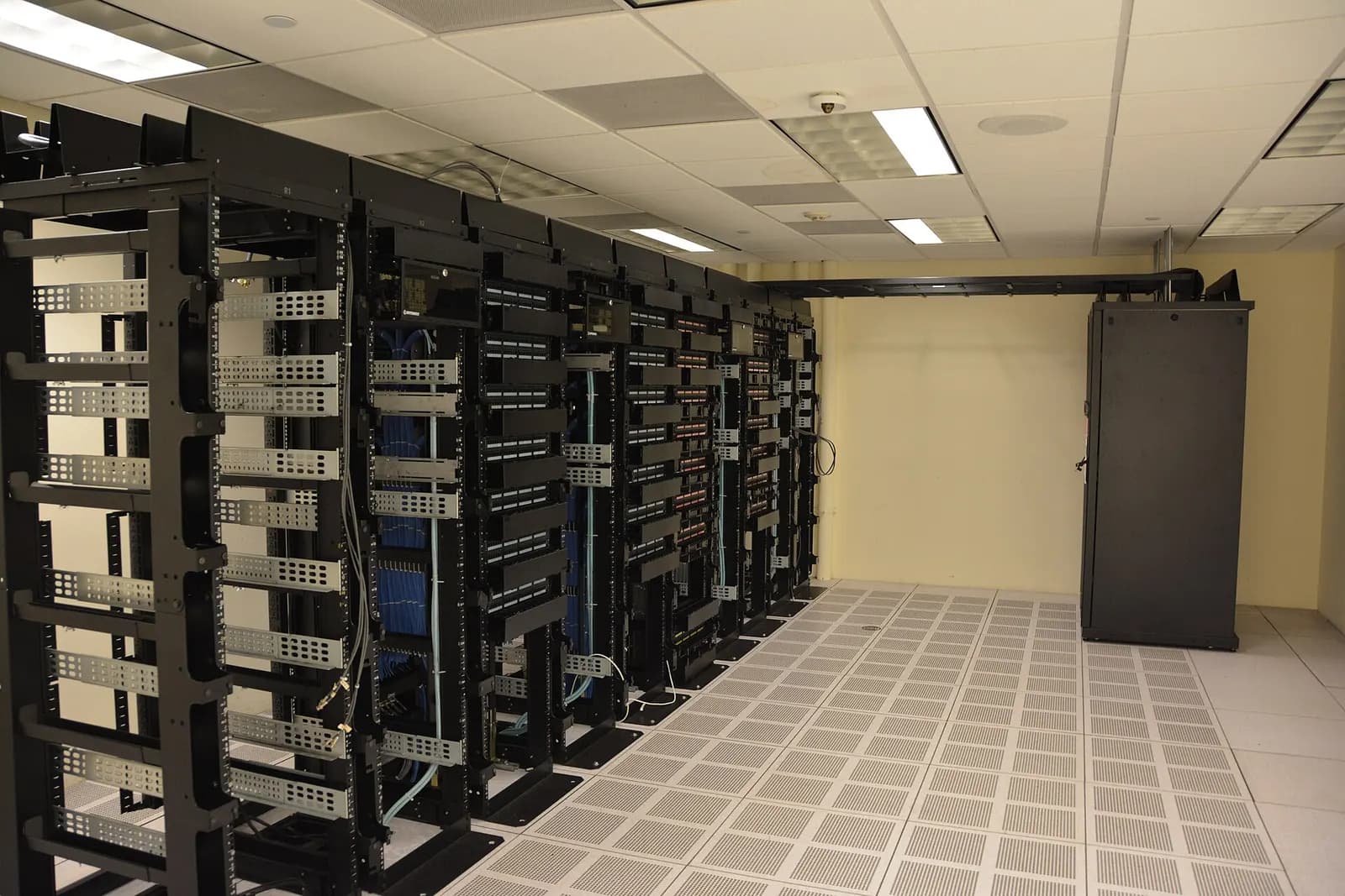 Rows of server racks with network cabling in a data center room