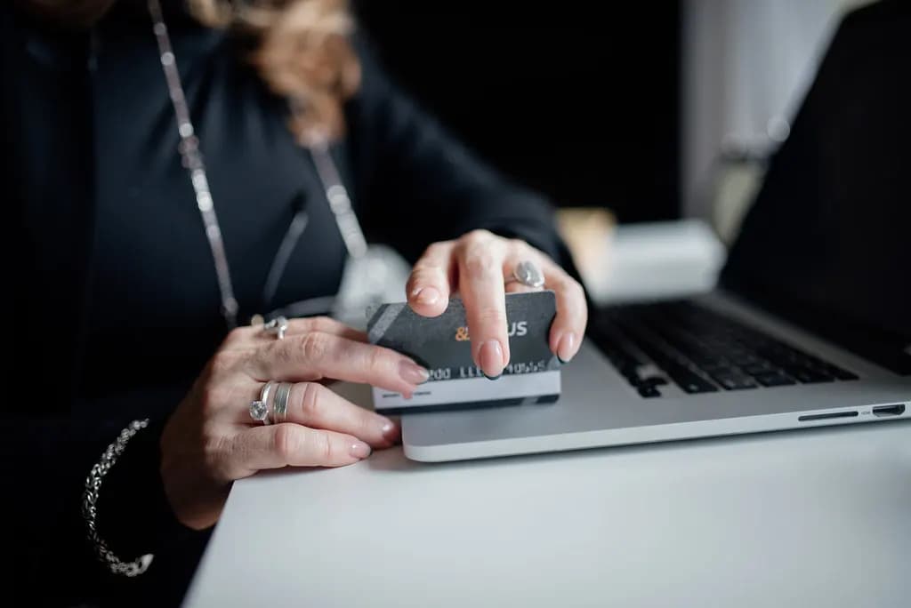 Shopper entering credit card details on a laptop to complete an online purchase