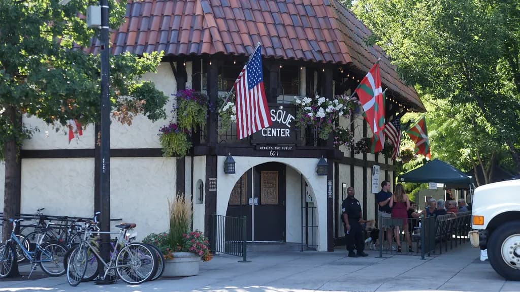Half-timbered building with flags and a sidewalk patio on the Basque Block in downtown Boise