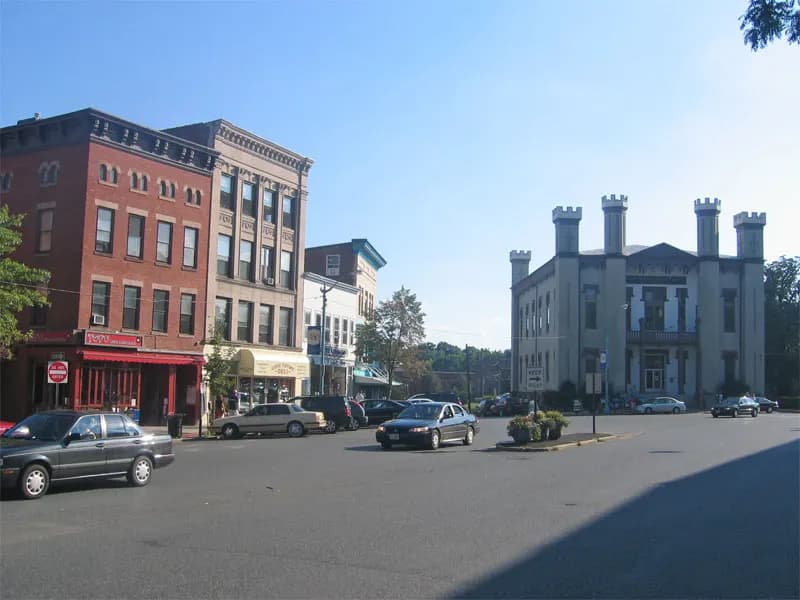 Brick shopfronts on Main Street in Northampton, Massachusetts, with the castle-like county courthouse across the street