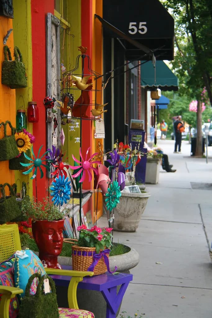Colorful independent shopfront with garden ornaments and planters on a downtown Asheville sidewalk