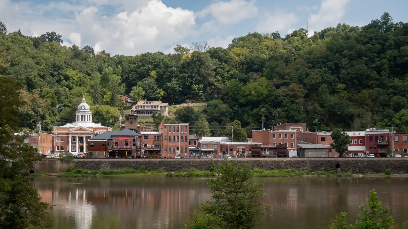 Brick storefronts and the domed Madison County courthouse in Marshall, North Carolina, along the French Broad River