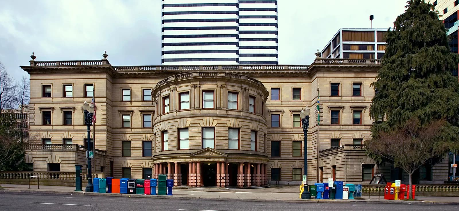 Portland City Hall in downtown Portland, Oregon, a four-storey Italian Renaissance style stone building with a rounded columned entrance