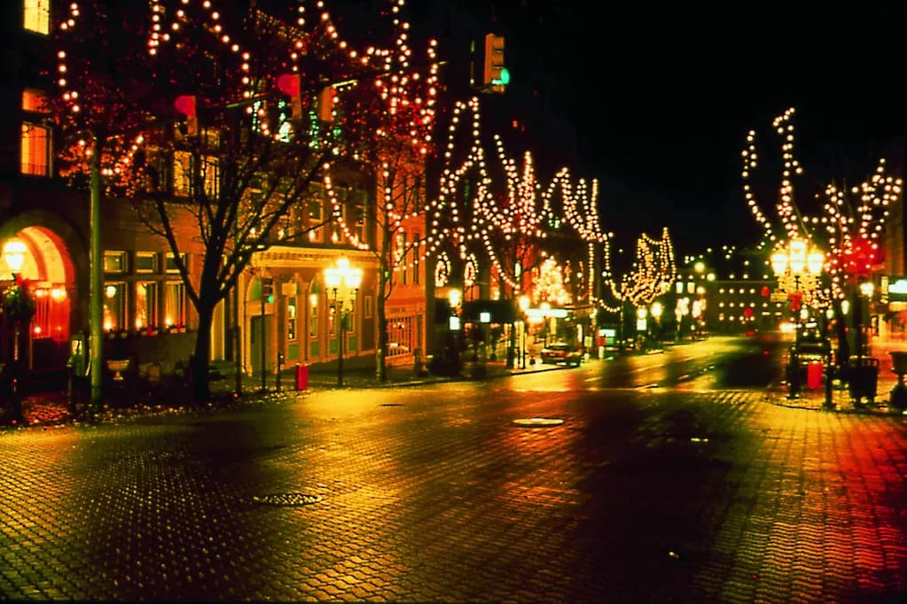 Main Street in Bethlehem, Pennsylvania at night with trees strung with lights in front of shops