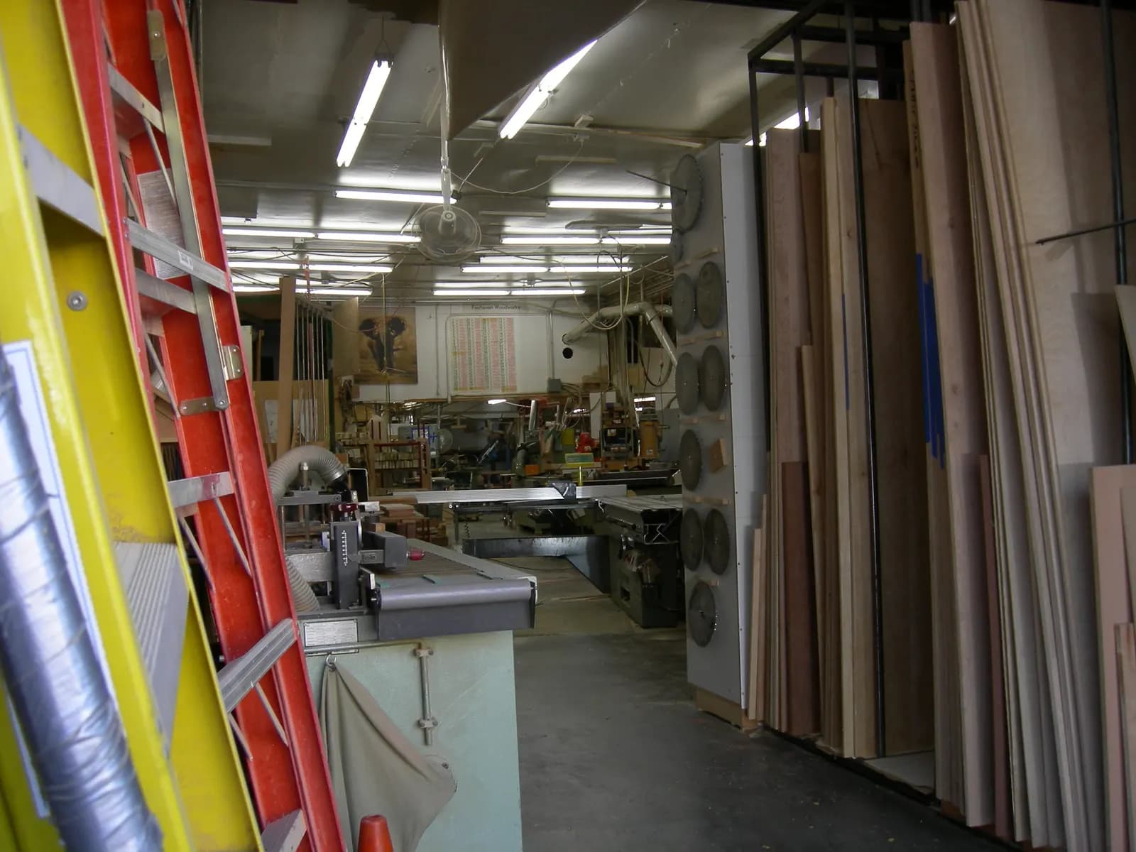Woodworking machinery and cabinet parts inside a small custom cabinet shop in Seattle