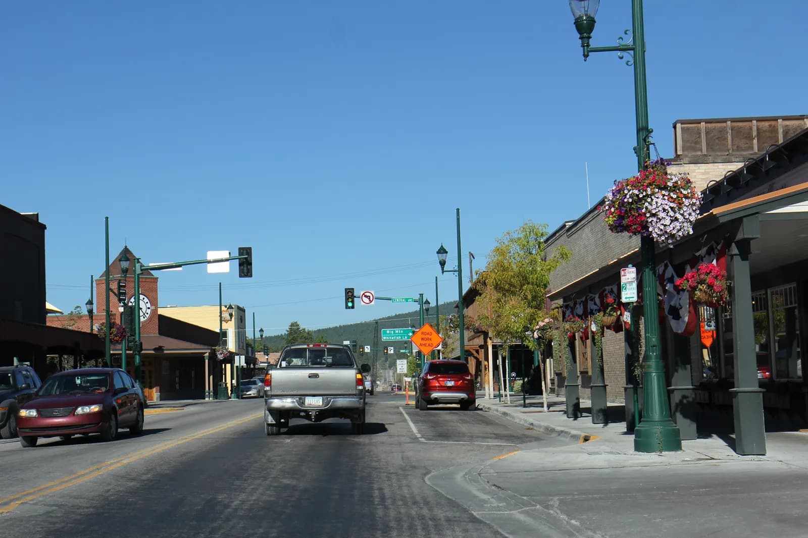 Central Whitefish, Montana, on US 93 with shopfronts, hanging flower baskets and traffic lights