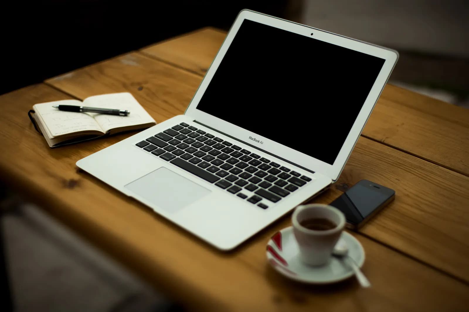 A home office workstation with a laptop, monitor and desk lamp used regularly and exclusively for business