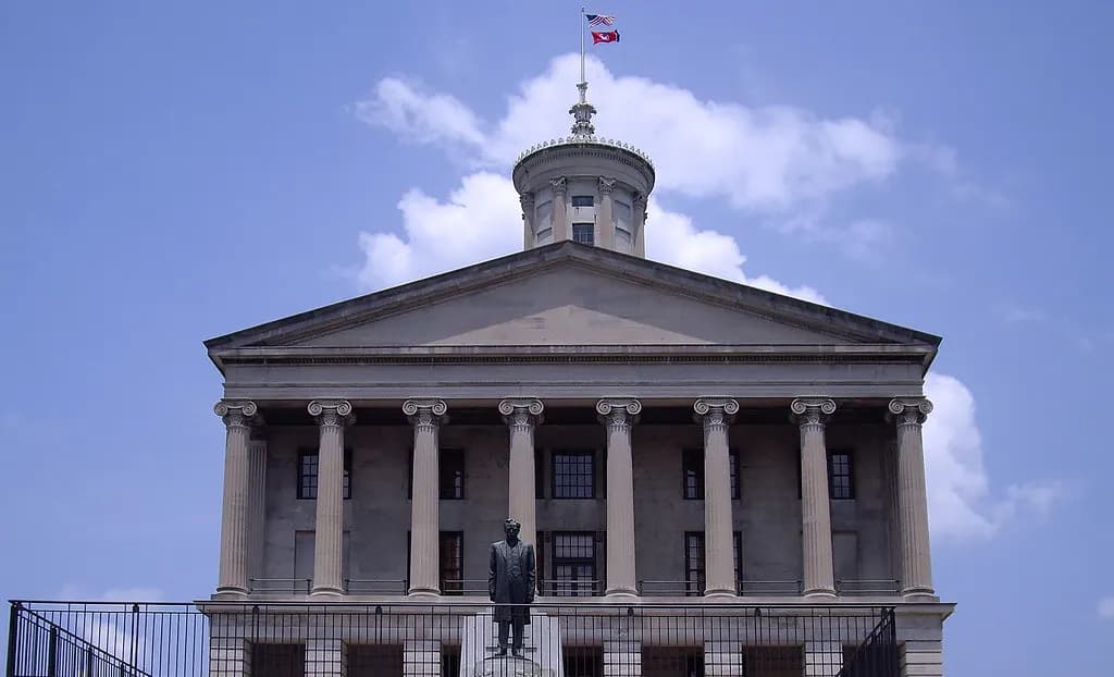 The Tennessee State Capitol in Nashville, a Greek Revival building with a tall columned tower, under a blue sky