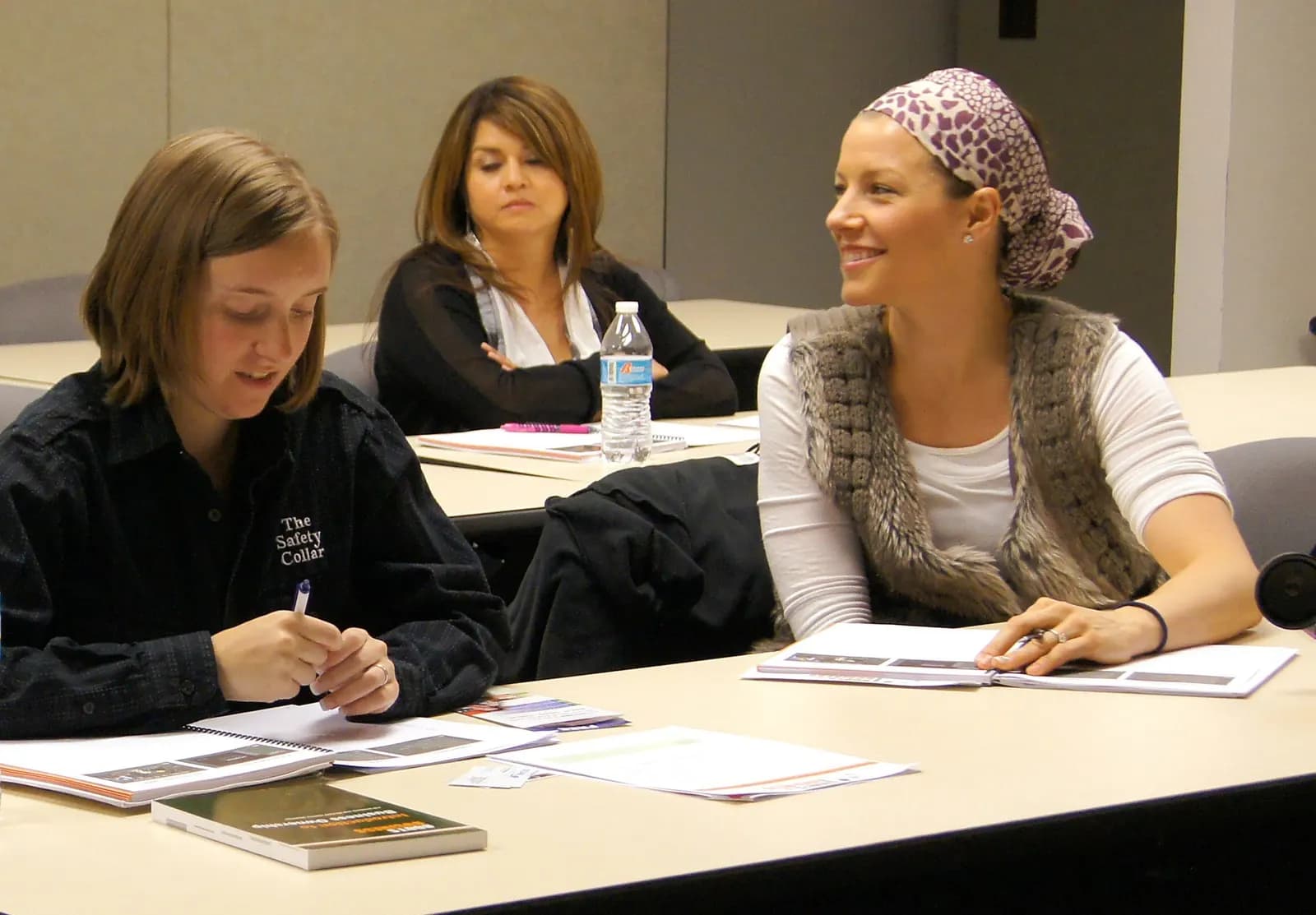 Veterans and family members taking notes at a Boots to Business workshop at an Arizona National Guard centre